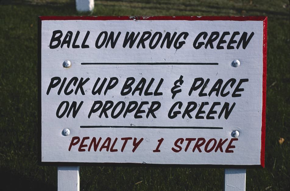 Ball on wrong green sign, Funspot mini golf, Route 3, Weirs Beach, New Hampshire, 1981