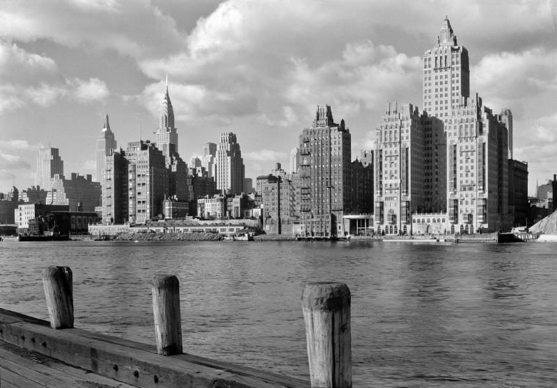 River House, 52nd St. and E. River, New York City. Shore line with clouds, December 1931