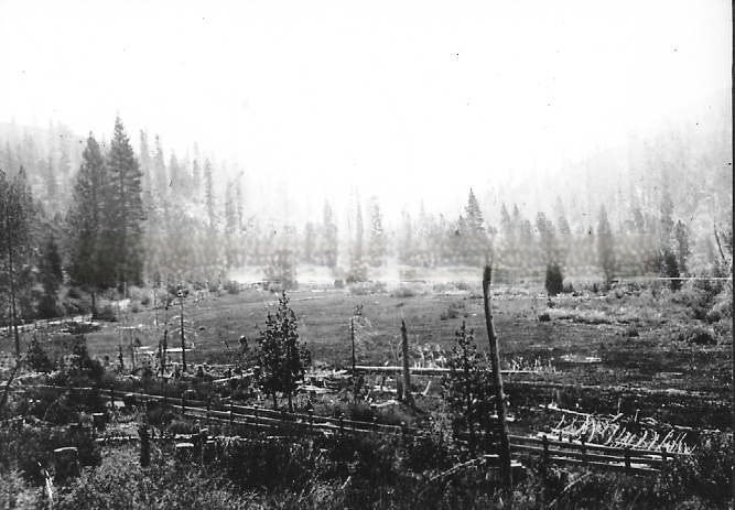 Early day mining camp as seen from a distance in its mountain setting, 1855