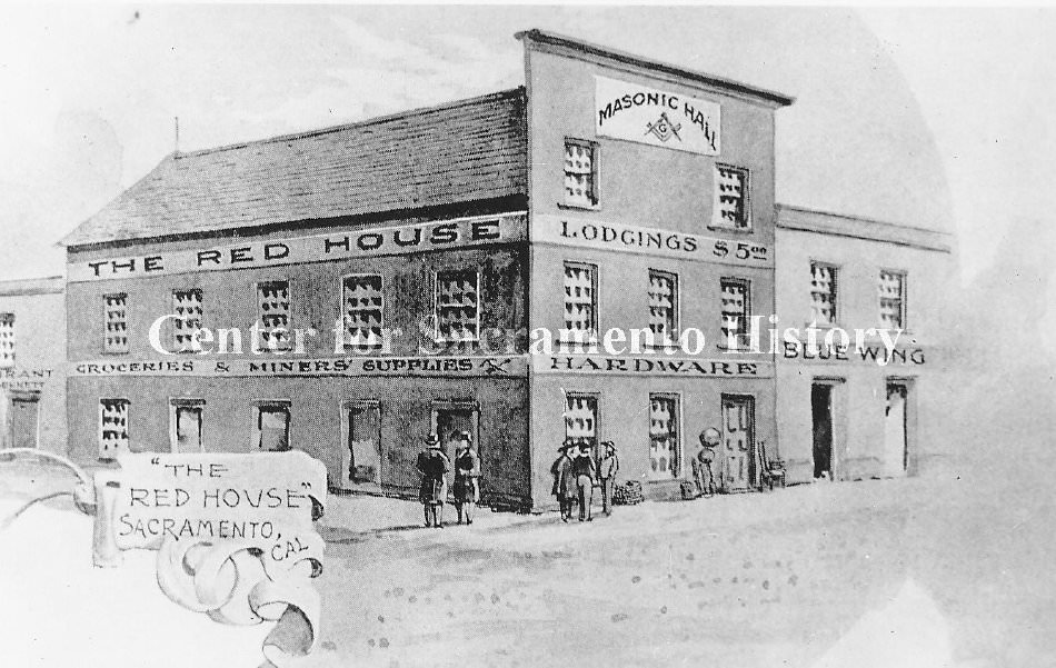 View of front of the Masonic Hall building containing the "Red House" for lodging and a hardware store with groceries and miners supplies, Sacramento, 1859