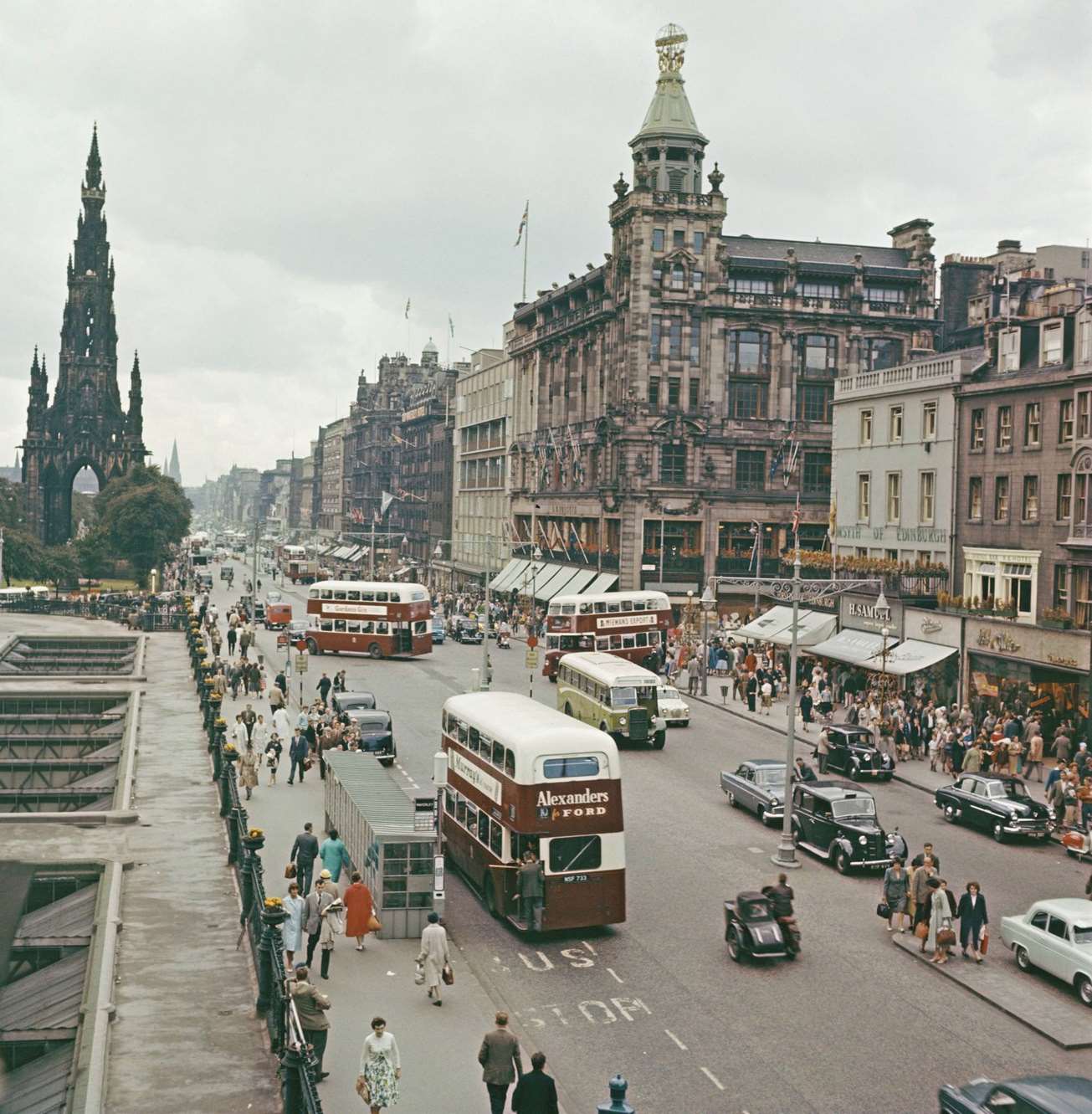 Buses, cars and pedestrians making their way along Princes Street in Edinburgh, Scotland during the Edinburgh Festival in 1960.