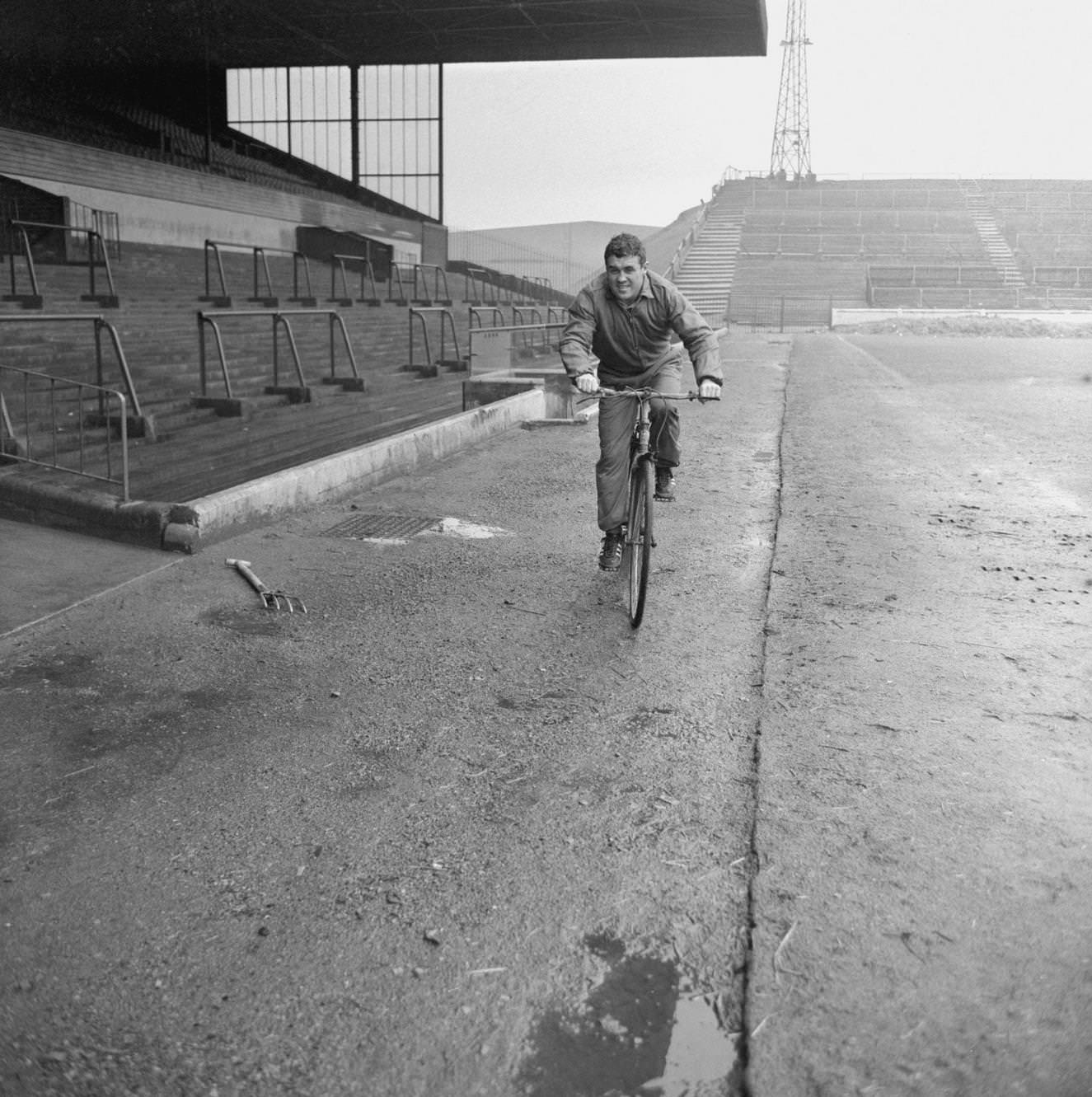 Leeds United and Scotland international Bobby Collins in training on a bike at Elland Road, 1960