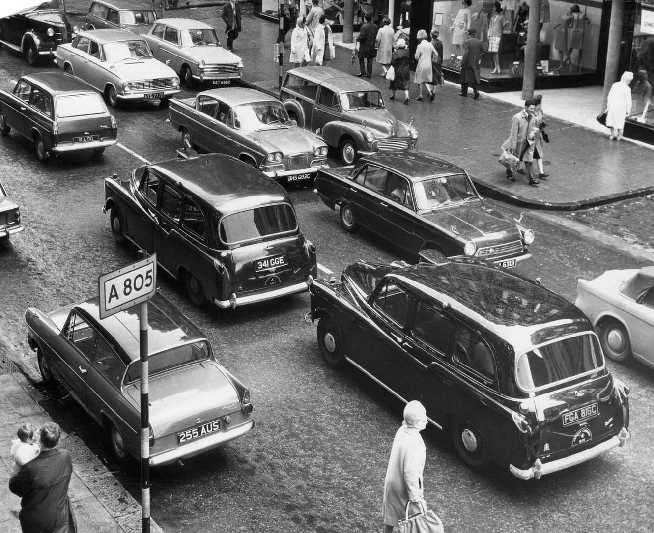 Taxis in a Glasgow street, stuck in traffic around the city centre, August 1965.