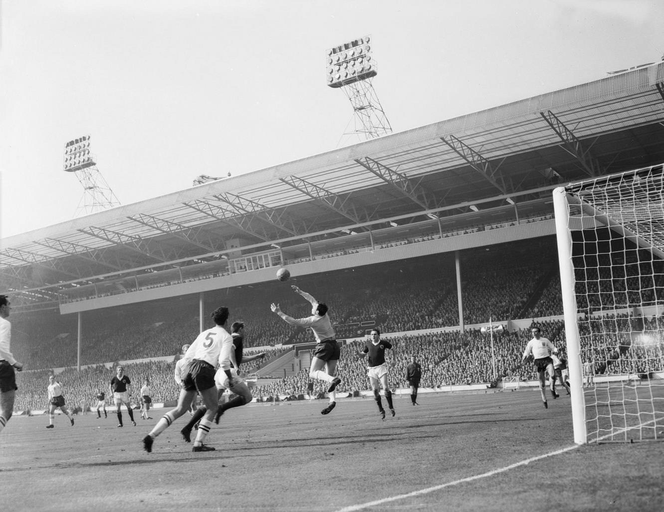 England goalkeeper Gordon Banks and centre-half Maurice Norman (No.5) beat off an attack by Scotland centre-forward Ian St John (behind Norman) during the soccer international at Wembley, 1963