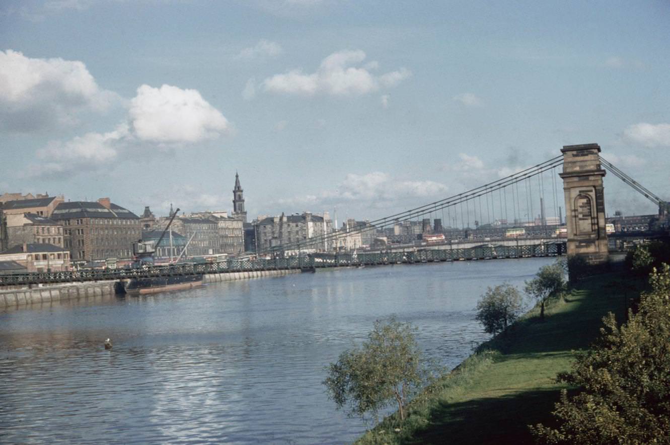 The south bank Laurieston and Gorbals area of the South Portland Street Suspension Bridge spanning the River Clyde in Glasgow, Scotland, 1965.