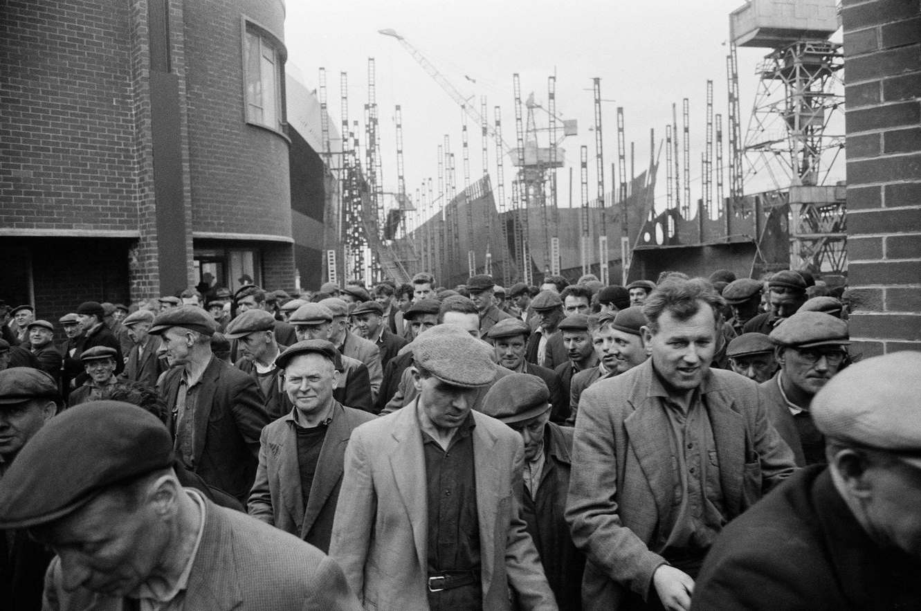 Shipbuilders leaving a shipyard at Greenock on the Clyde, Scotland, 1963.
