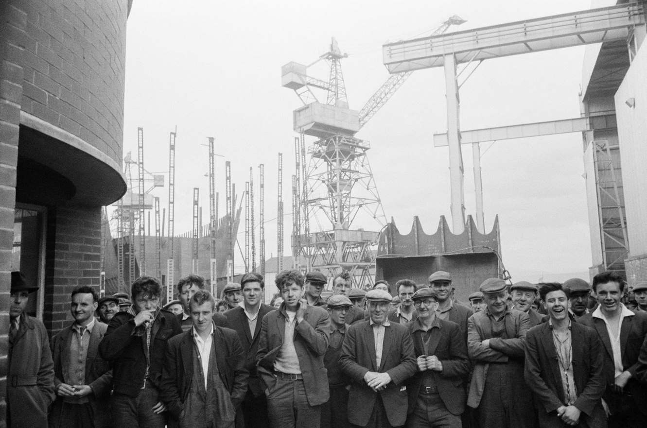 Shipbuilders leaving a shipyard at Greenock on the Clyde, Scotland, 1963.