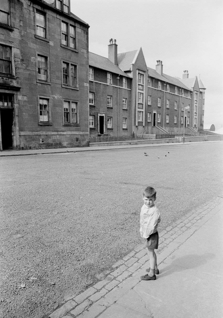 A boy in a street in the shipbuilding town of Greenock on the Clyde, Scotland, 1963.