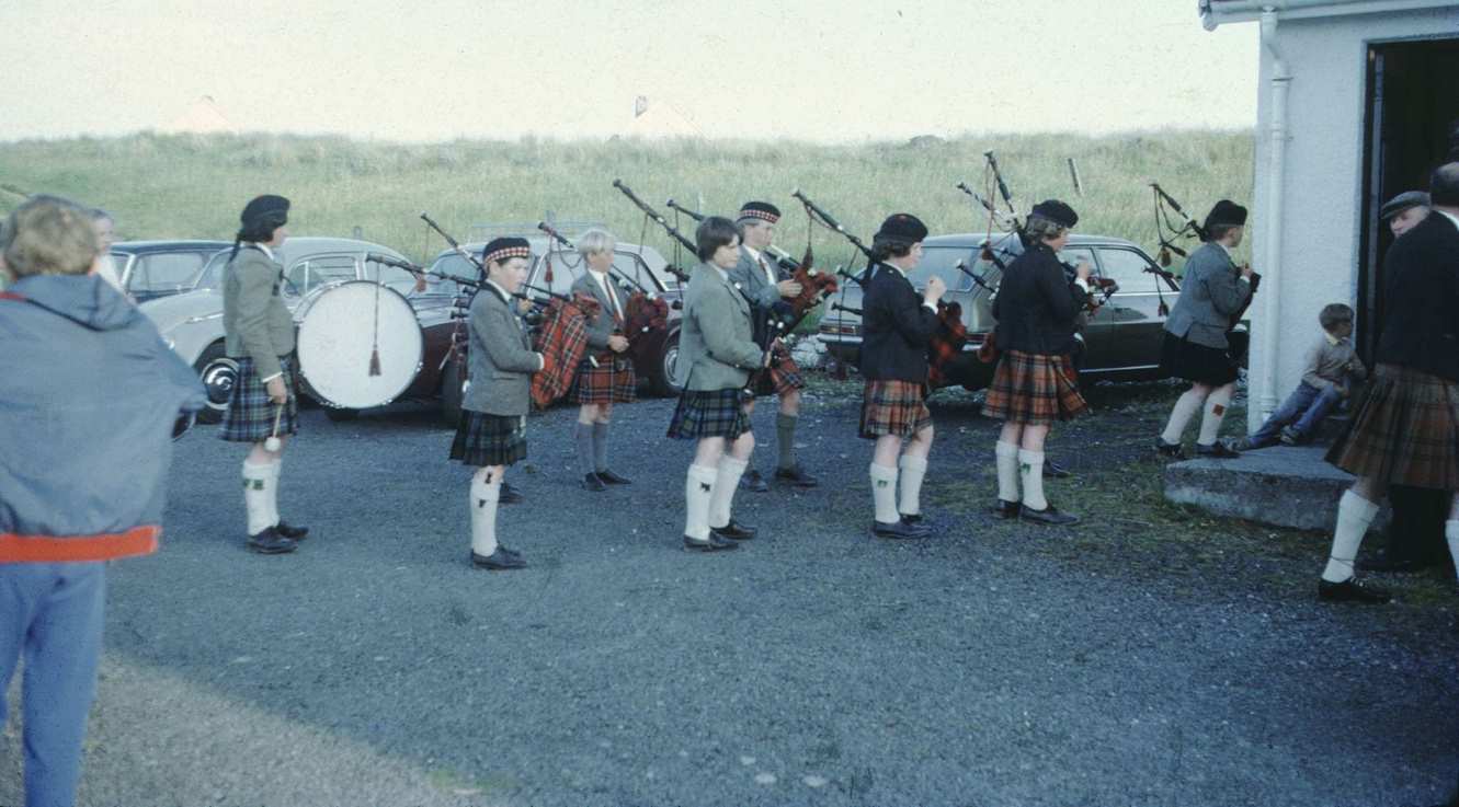 Vernacular snapshot photograph of bagpipers in Scotland, 1960.