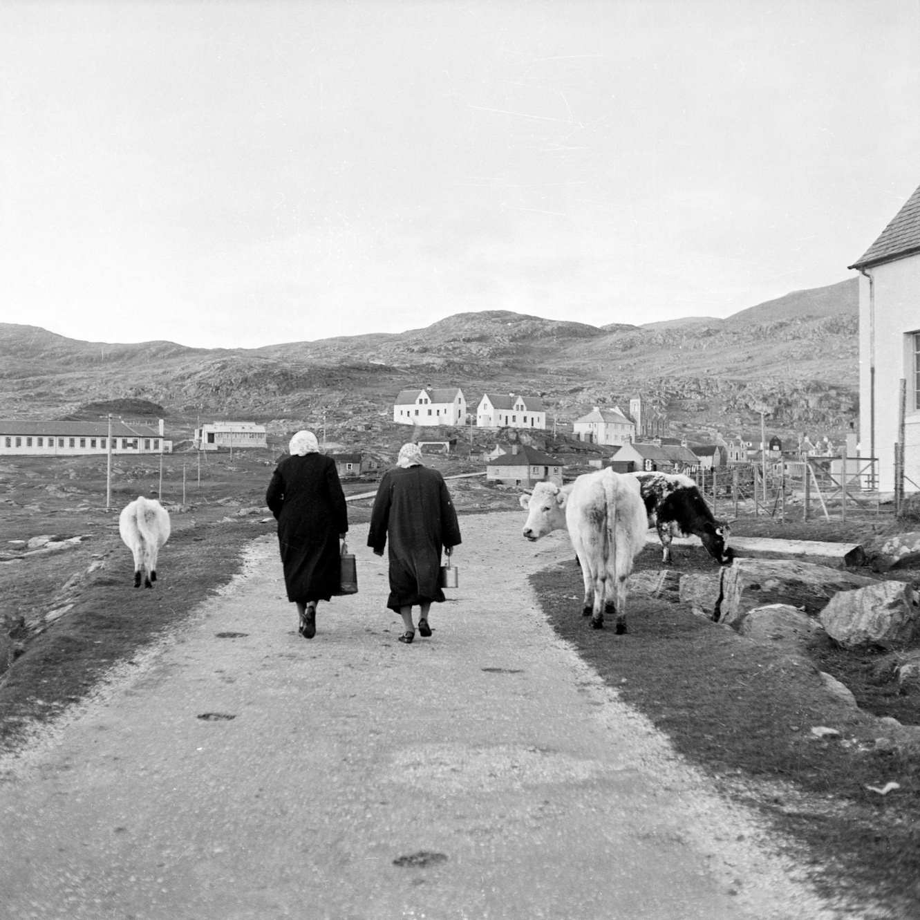 Two women walking on a road on the island of Barra in the Outer Hebrides, 1960