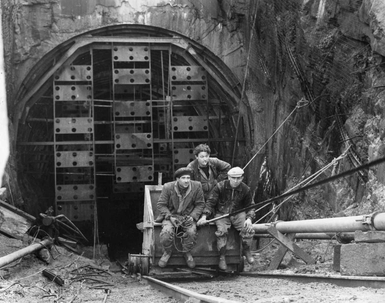 Workers being hoisted up from one of four anchor tunnels to hold securing cables of the Forth Road Bridge, which crosses the river near Edinburgh, 1960