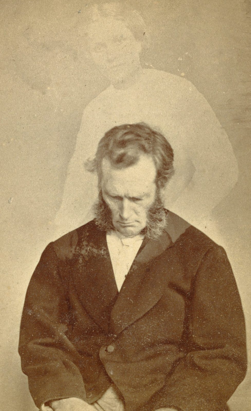 Portrait of Bronson Murray with full sideburns looking down. A faint image of a woman is visible above him.
