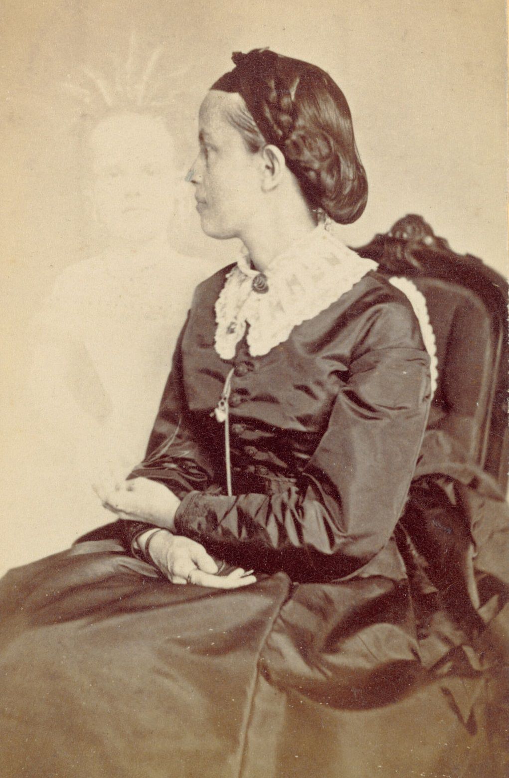 Profile portrait of Ella Bonner, with a faint image of a child visible next to her.