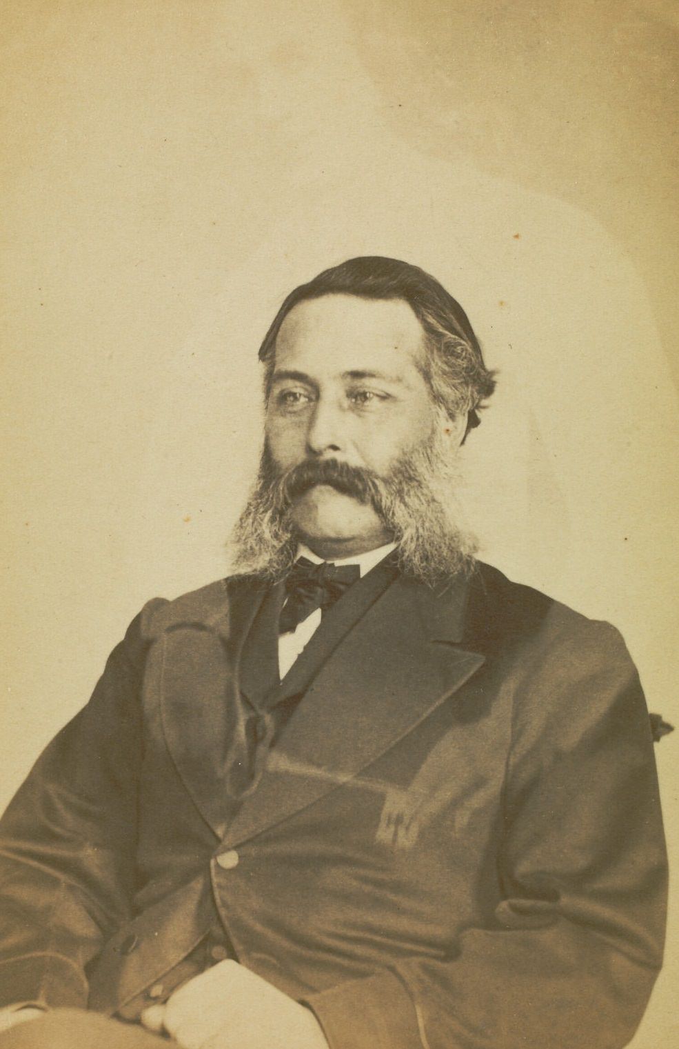 Portrait of L.A. Bigelow with mutton chop whiskers, with the faint image of a woman visible behind him.