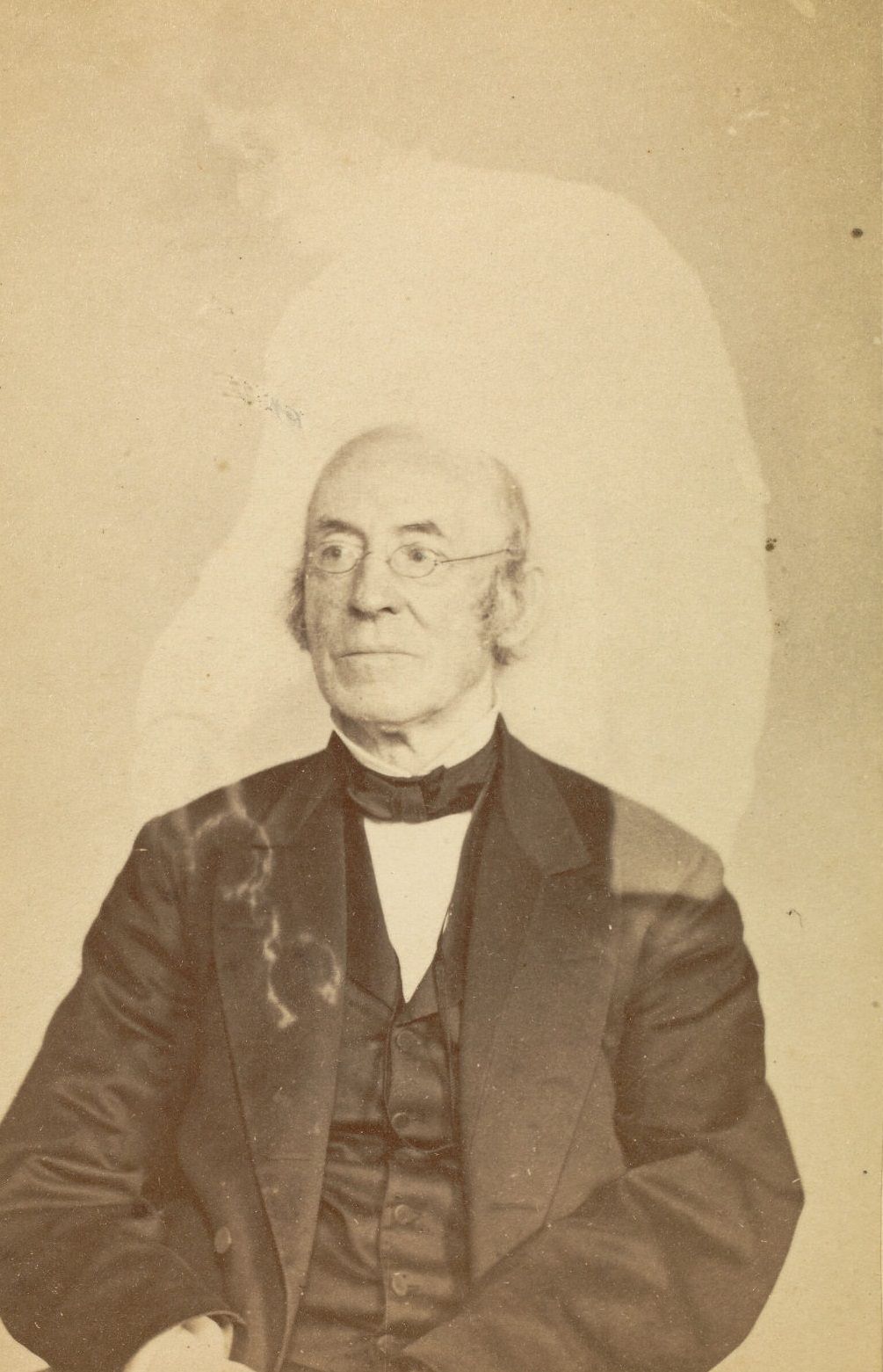 Portrait of William Lloyd Garrison with the faint image of a woman above him.