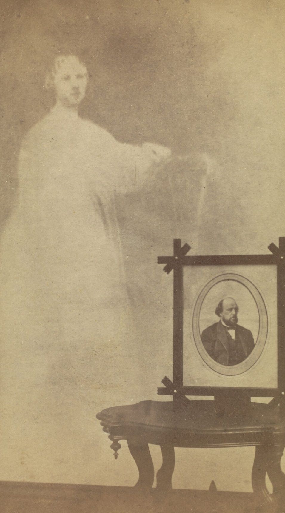 A framed portrait of Mr. Brown perched on a side table, with the faint image of a woman next to it.