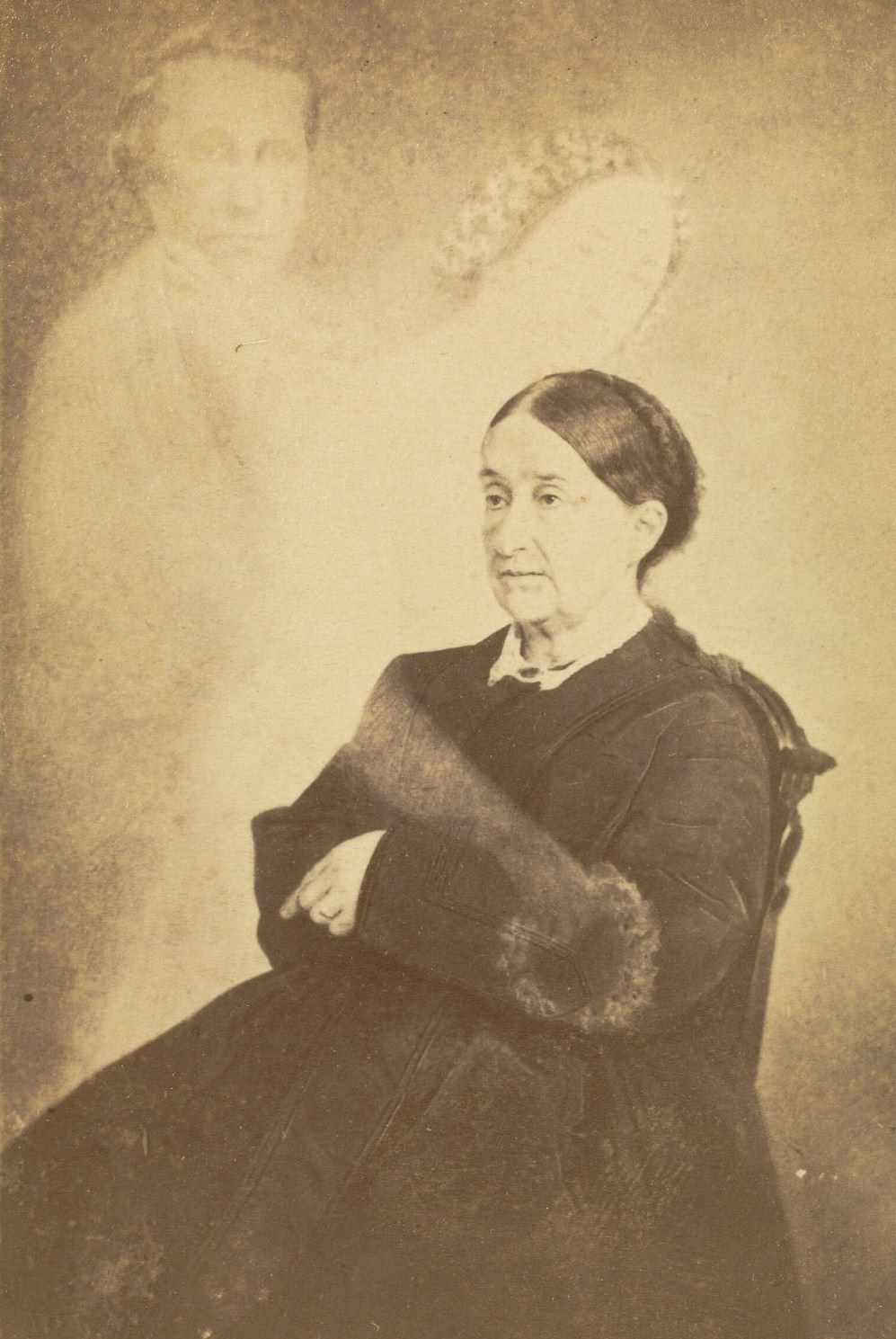 Portrait of Mrs. Swan with her arms crossed. Faint images of a man and a woman reaching out her hand are next to Mrs. Swan.