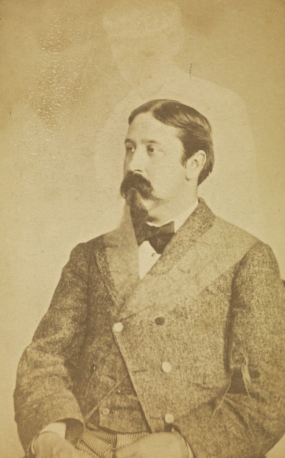 Portrait of Charles H. Foster with a mustache and goatee. A faint image of a woman appears above him.