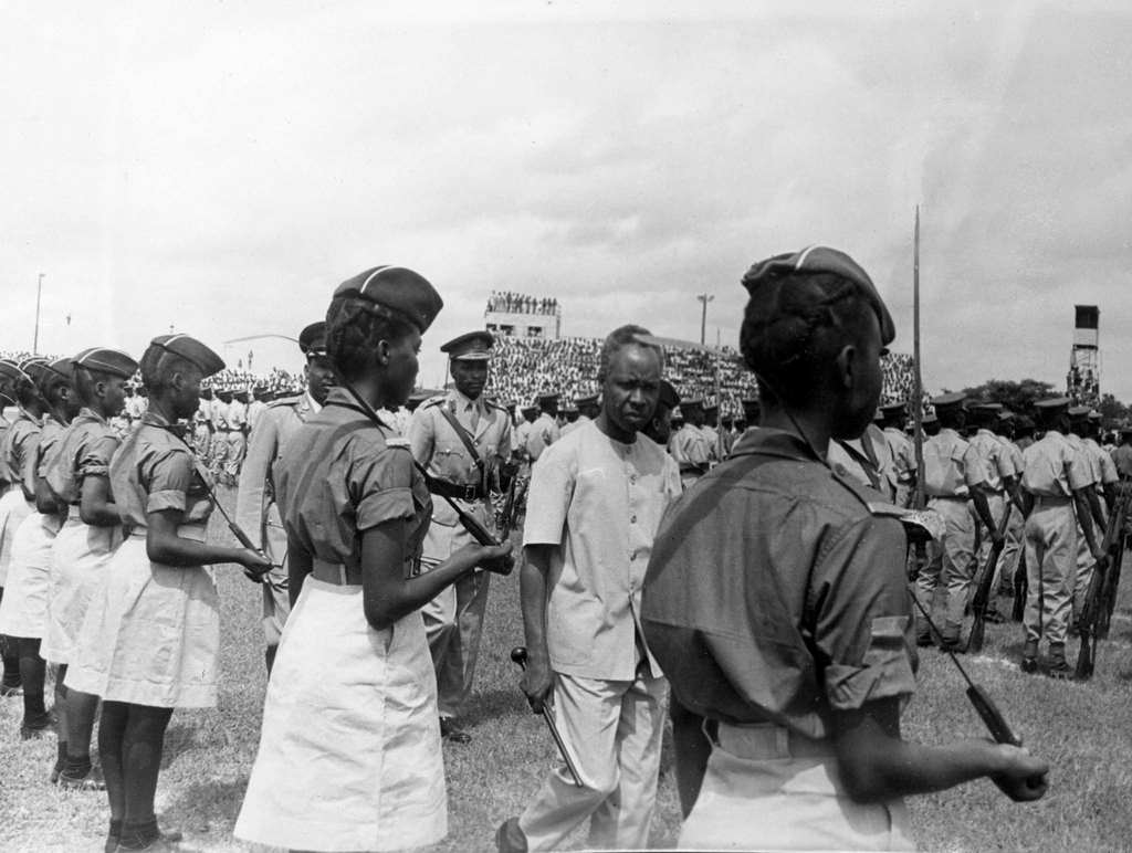 Tanzanian President Julius Nyerere inspecting a contingent of young national service women who carry long knives over their shoulders, in Dar es Salaam, Tanzania on May 2, 1968.