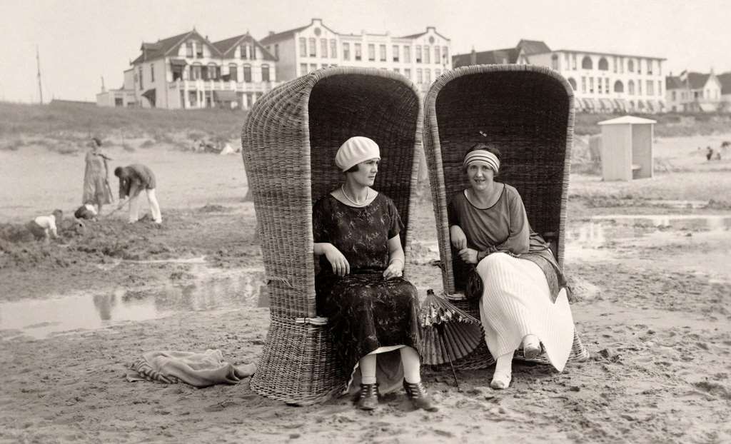 Donkey rides at the seaside, with the pier behind, in Scheveningen near The Hague in the Netherlands, 1924.