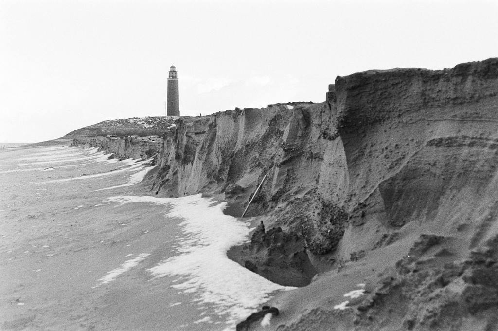 After this week's heavy storm a large part of the island Texel has disappeared, lighthouse in the background, The Netherlands, 1940s