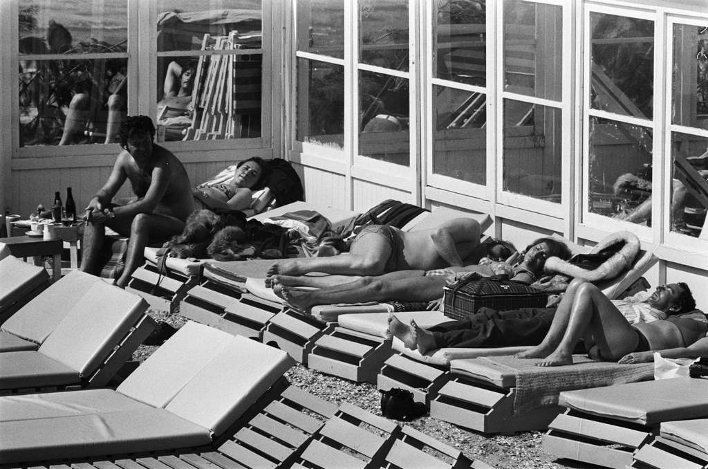 Sunbathing people on beach, April 20, 1975.