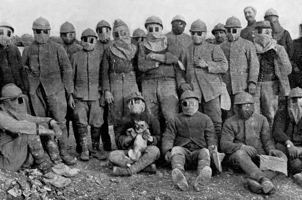 French soldiers with dog wearing gas masks during gas mask parade in trench, Western Front, World War 1, 1916.