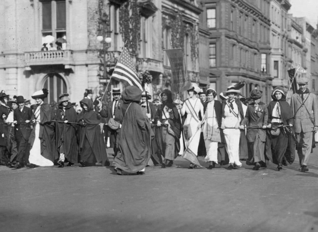 The women who walked from New York to Washington in February to attend President Woodrow Wilson's inauguration occupy a position of honour at a Women's Suffrage Parade