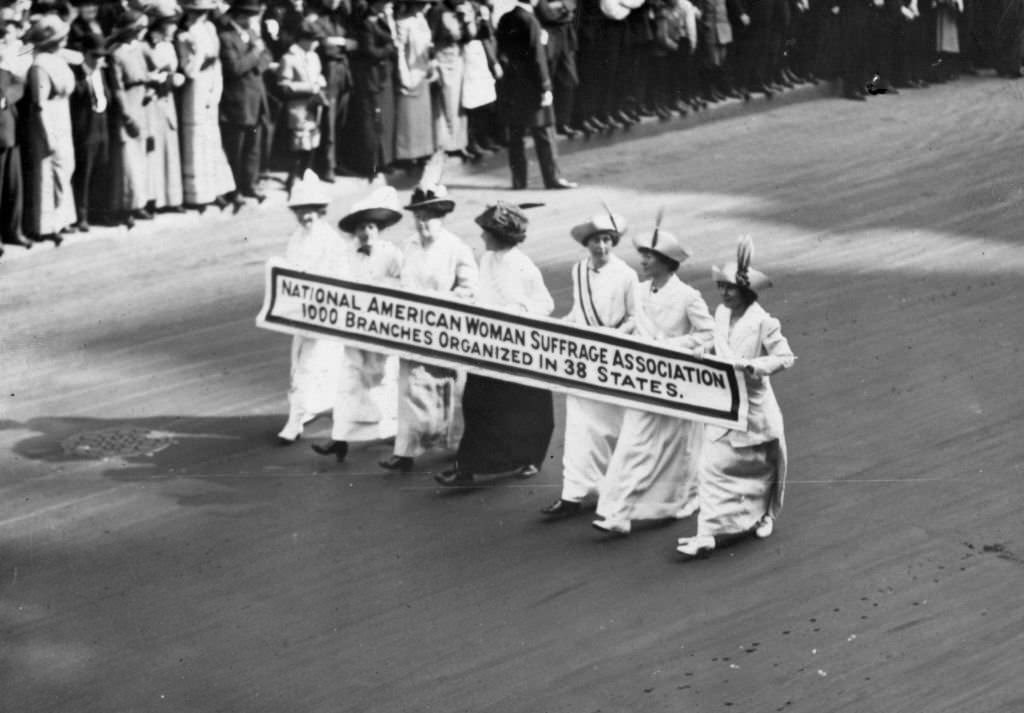 Members of the National American Woman Suffrage Association marching with a banner which publicises their '1000 branches organized in 38 states' at the New York Suffragette Parade.