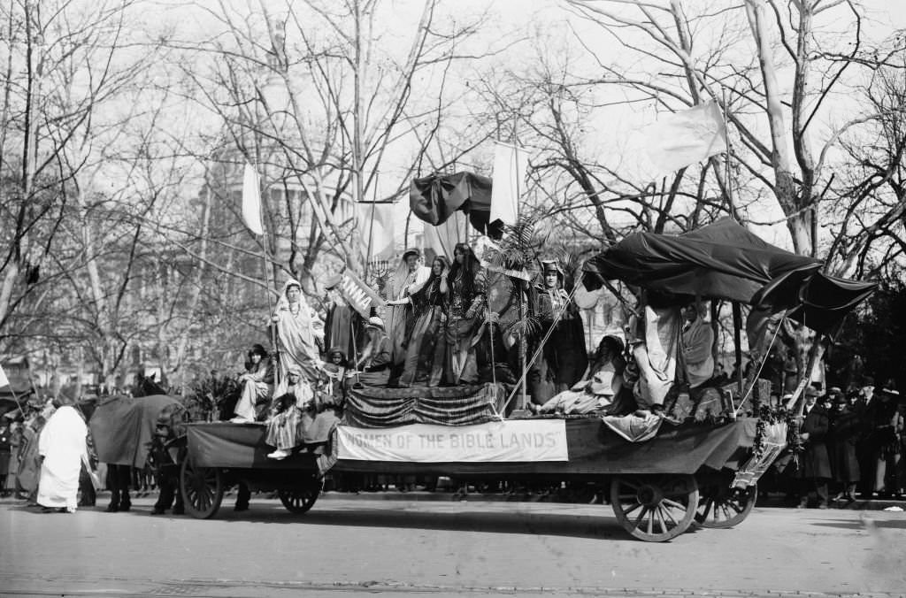 Woman Suffrage Parade held in Washington, D.C., March 3, 1913 showing a float with banner 'Women of the Bible Lands' passing the U.S. Capitol.