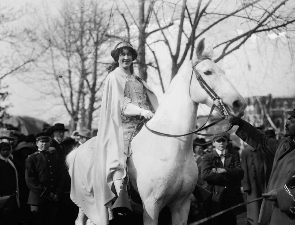 Inez Milholland Boissevain, wearing white cape, seated on white horse at the National American Woman Suffrage Association parade, March 3, 1913