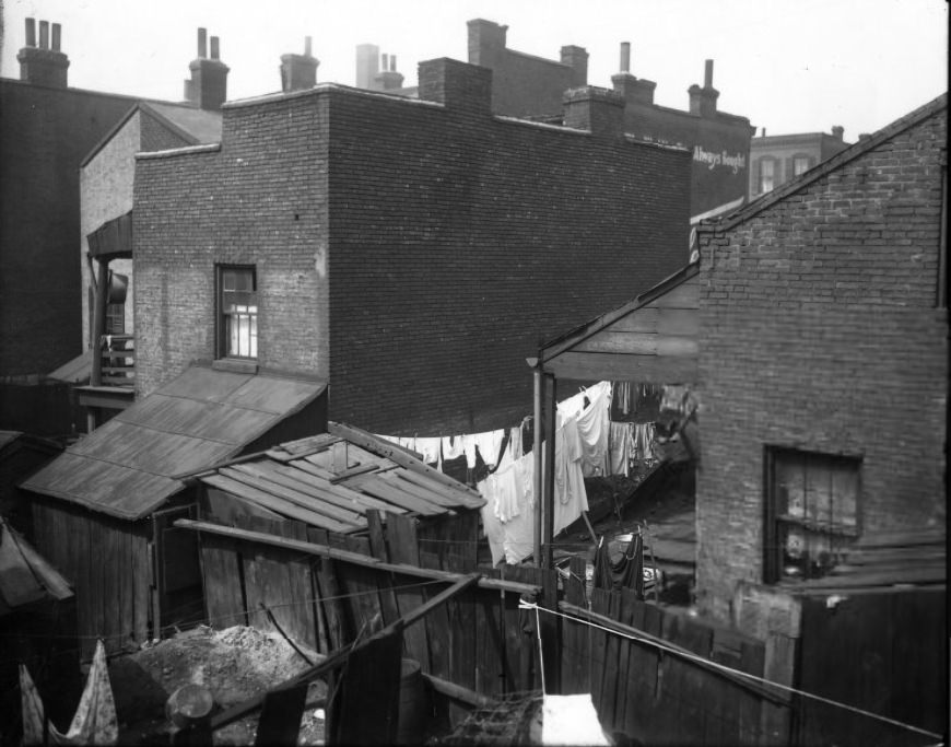 Rear of urban residential housing showing laundry drying, 1907