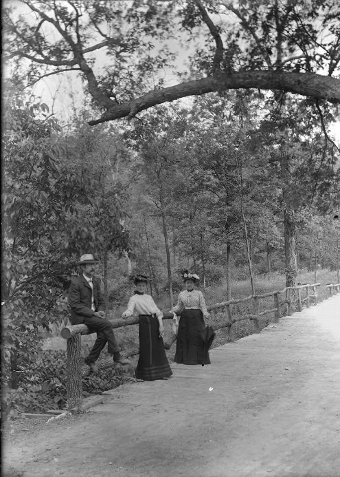 Three People Leaning on a Wooden Railing, 1901