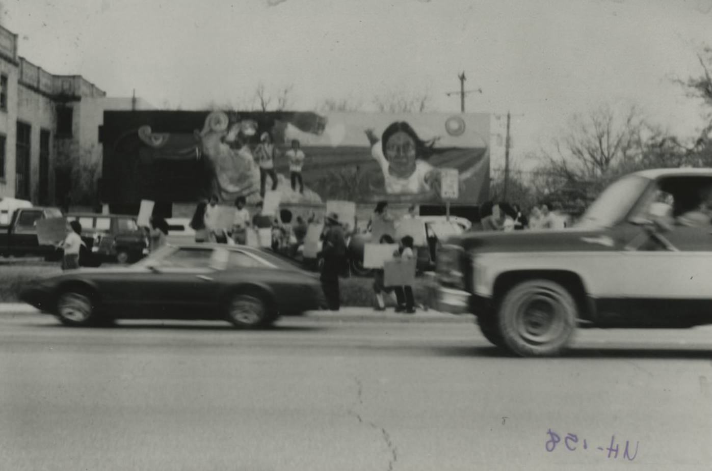 A protest to save Juarez-Lincoln University and mural (by Raul Valdez) at East 1st Street and I-35 in Austin, 1979