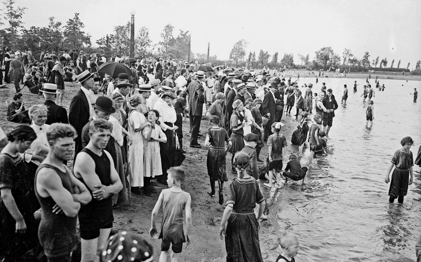 Swimmers and spectators on the shoreline of Lake Michigan at Diversey Beach, in the Lincoln Park community, Chicago, Illinois, 1915.