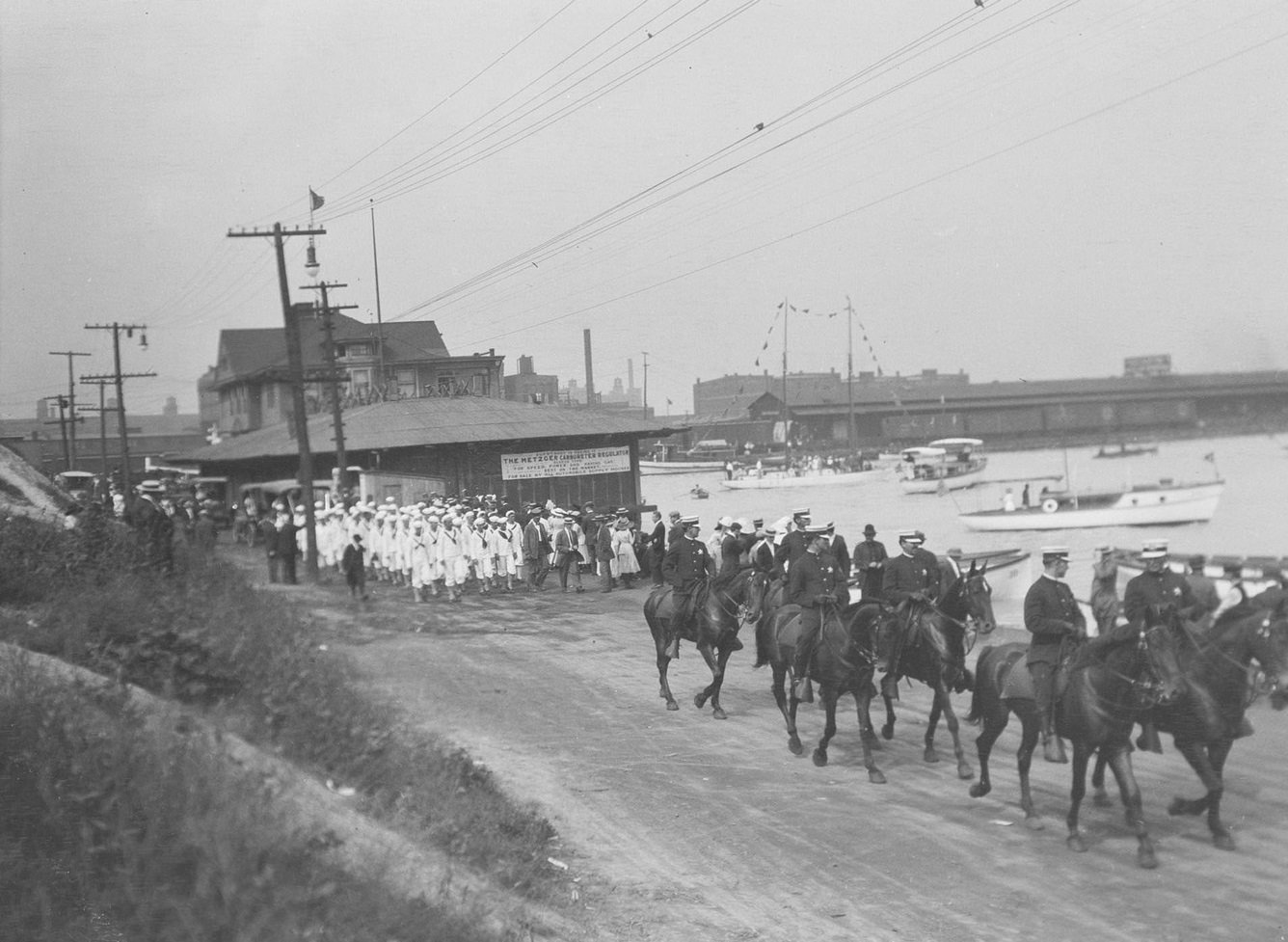 Sailors from the USS Wolverine of the Navy following mounted Chicago policemen, Chicago, Illinois, 1910s.