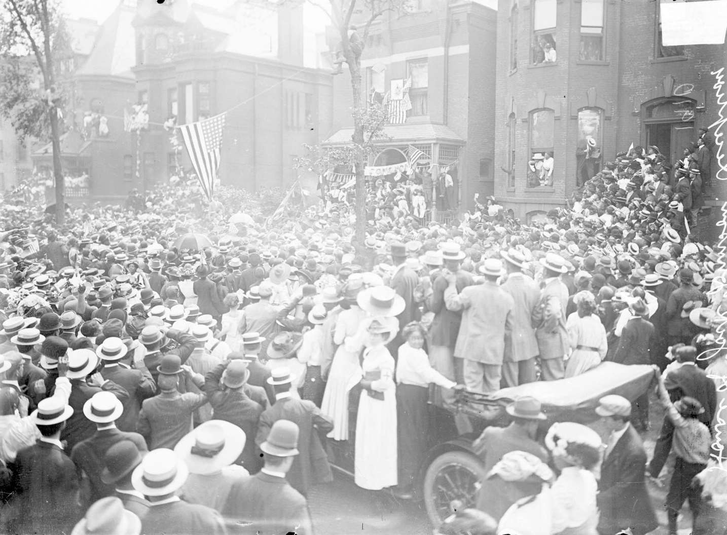 A large crowd of people gathering on the street in front of a house where Jack Johnson's reception was taking place in Chicago, 1910.
