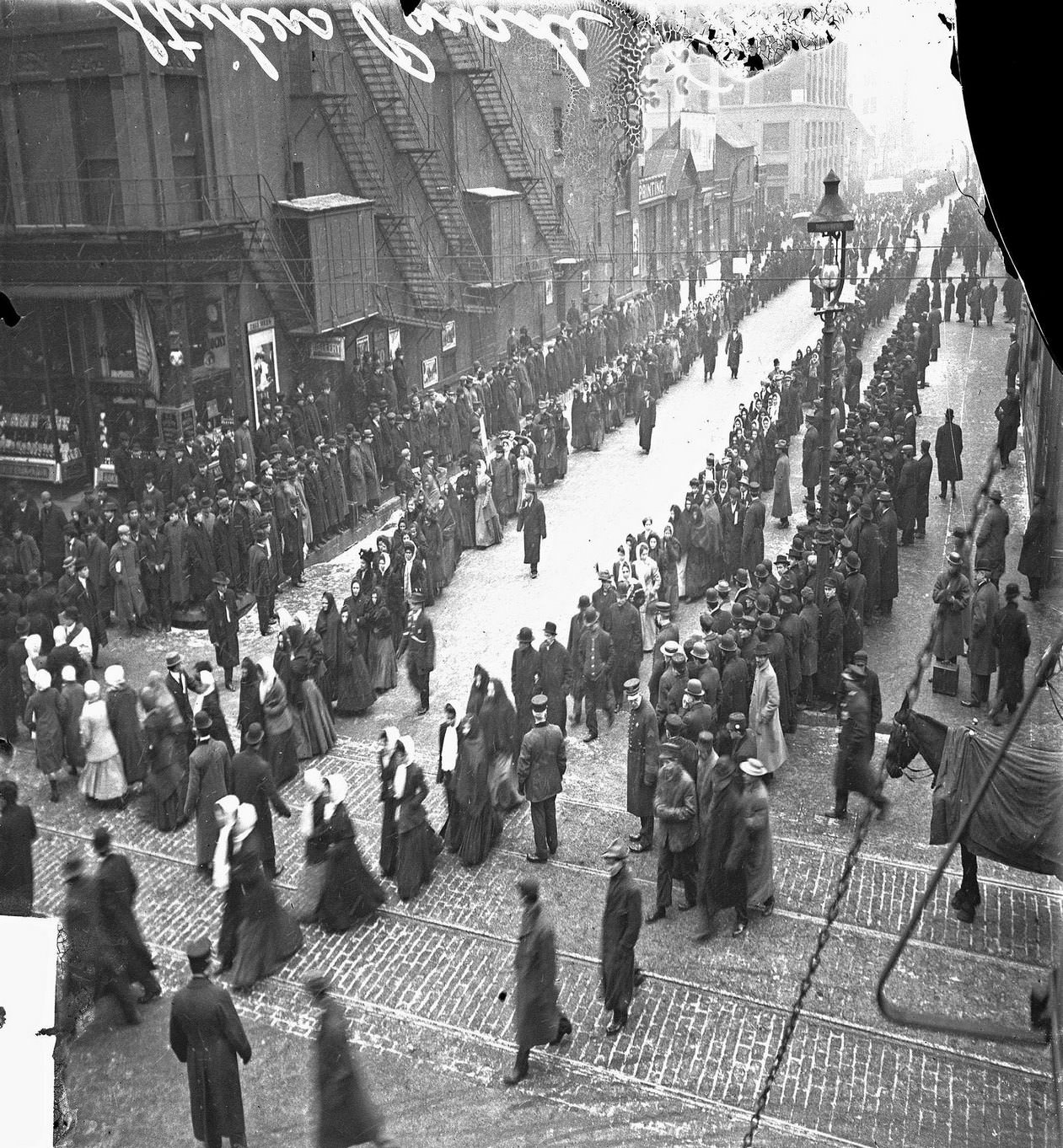 A parade of men and women along West Jackson Boulevard during the United Garment Workers of America strike, Chicago, Illinois, December 12, 1910.