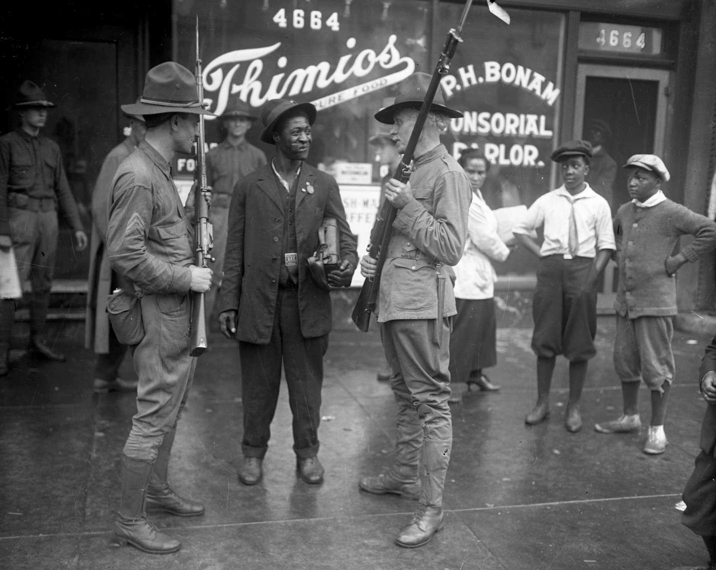 Members of the state militia talk with a man during the Chicago race riots of 1919.