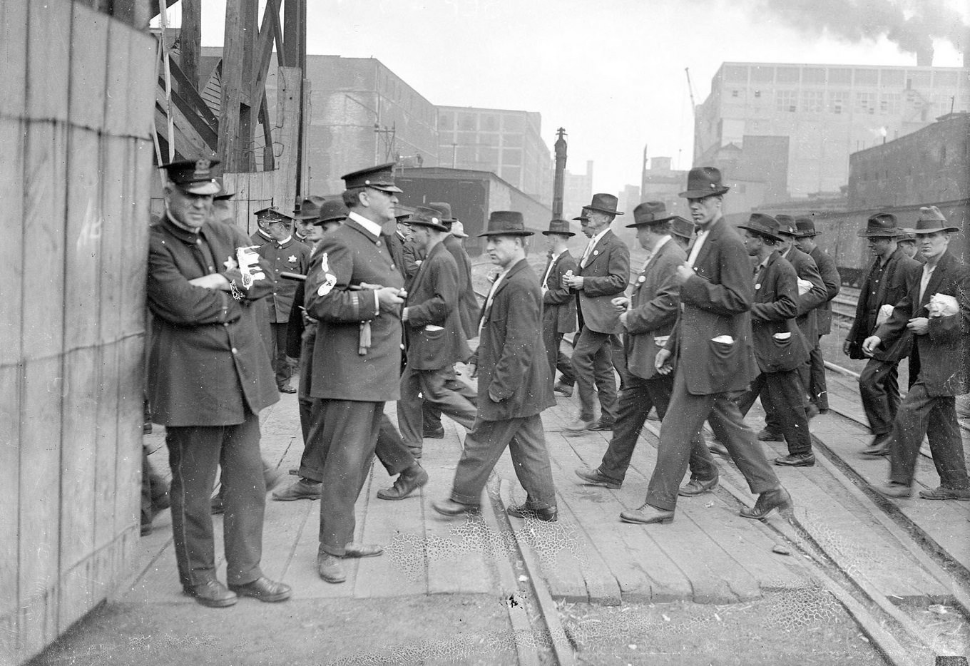 Packinghouse workers during their walkout, crossing train yards, Chicago, Illinois, 1919.