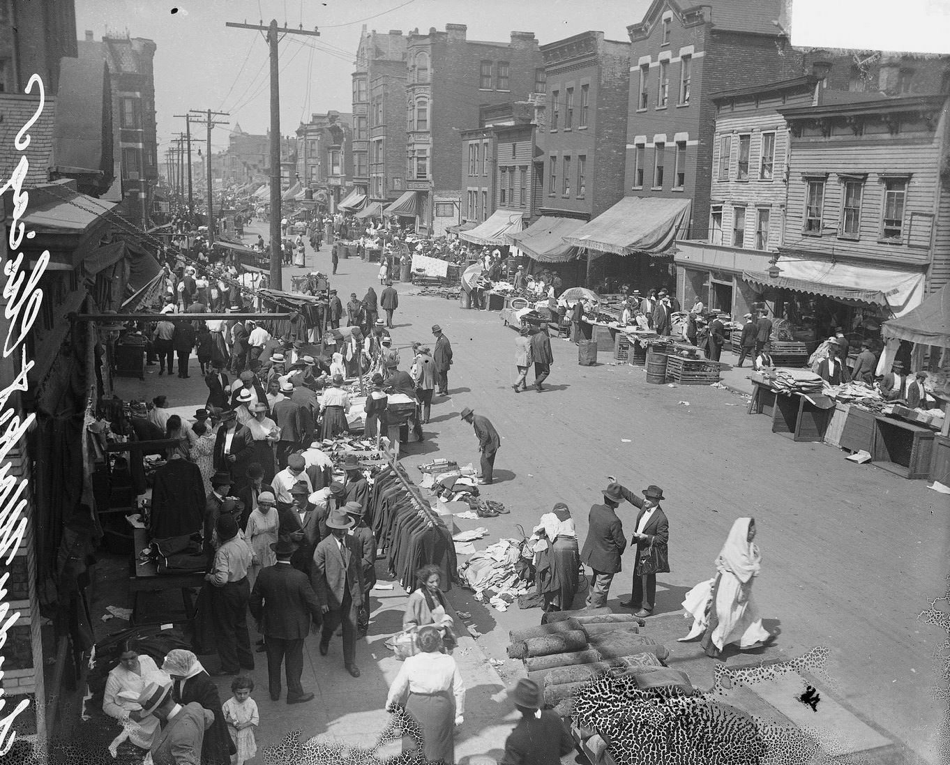 The merchants and shoppers along Maxwell Street at the Sunday market in the city's Jewish community located in the Near West Side community area, Chicago, Illinois, 1917.