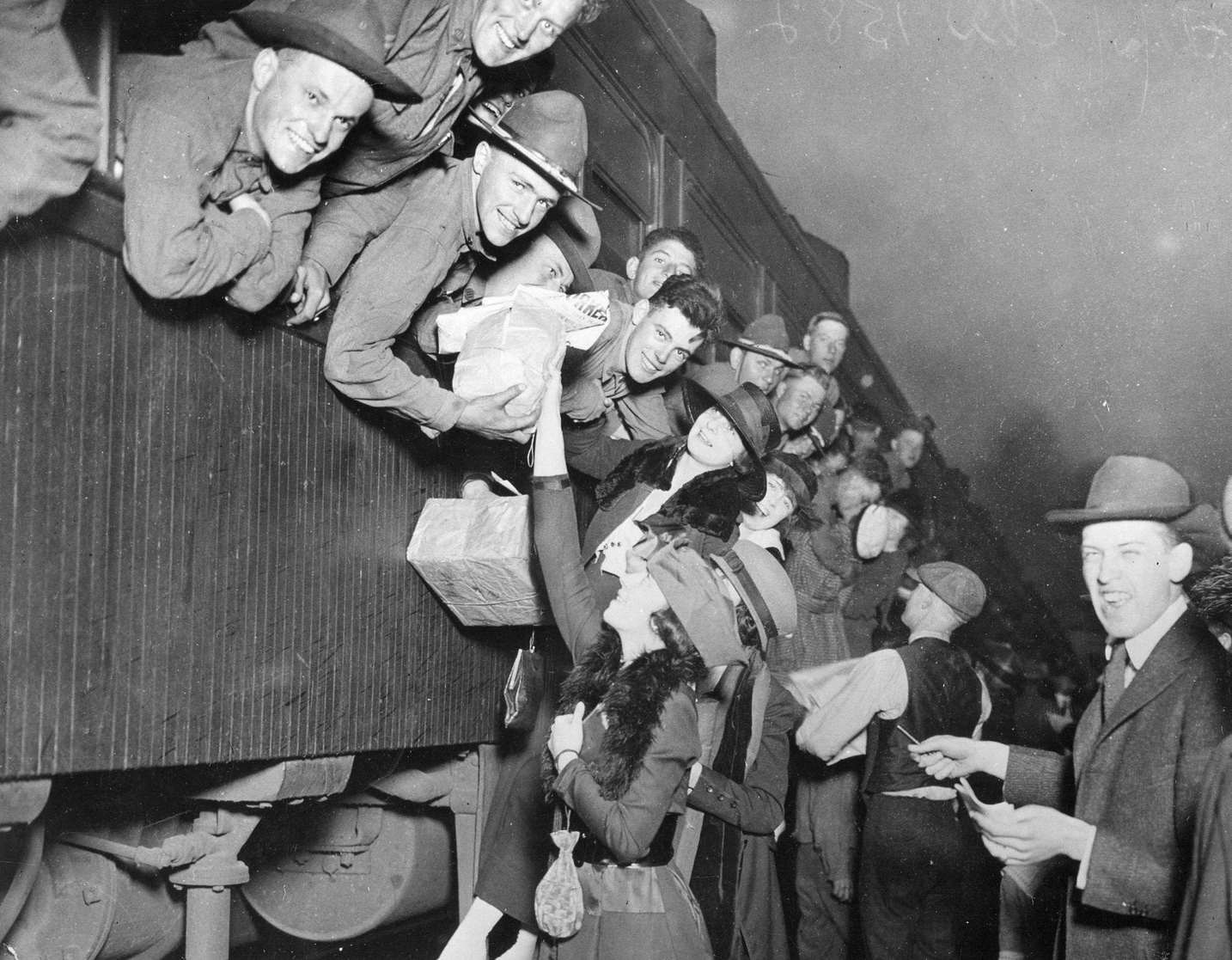 American draftees as they hang excitedly out of the windows of a train as they wait to leave for World War I training and combat, Chicago, Chicago, Illinois, 1917