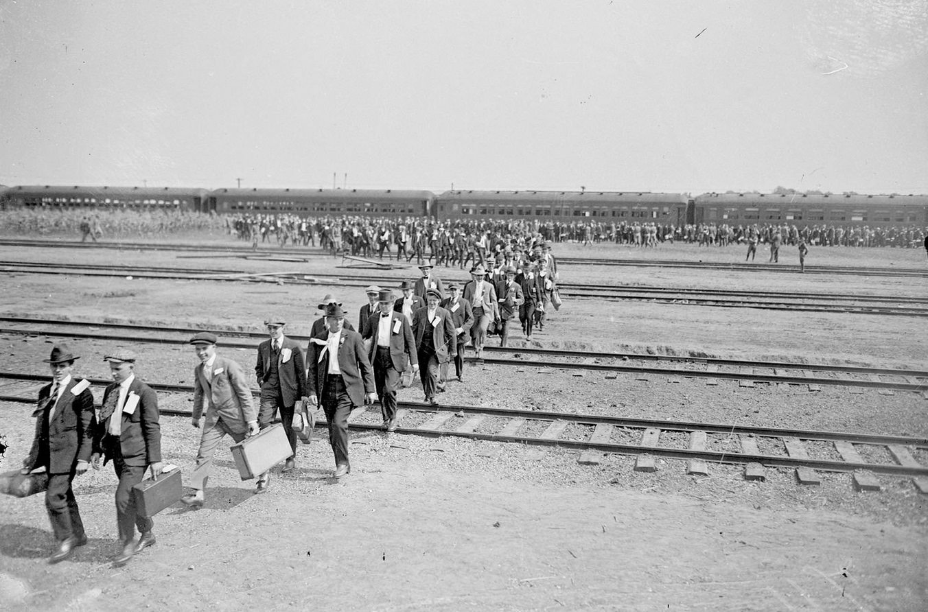 Recruits from Chicago, Illinois, walking across railroad tracks at Camp Grant in Rockford, Illinois, Chicago, Illinois, 1917.