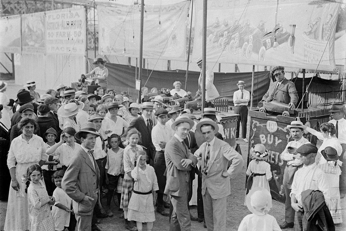 Spectators standing outside the monkey show booth at Riverview Park, Chicago, Illinois, July 16, 1916.