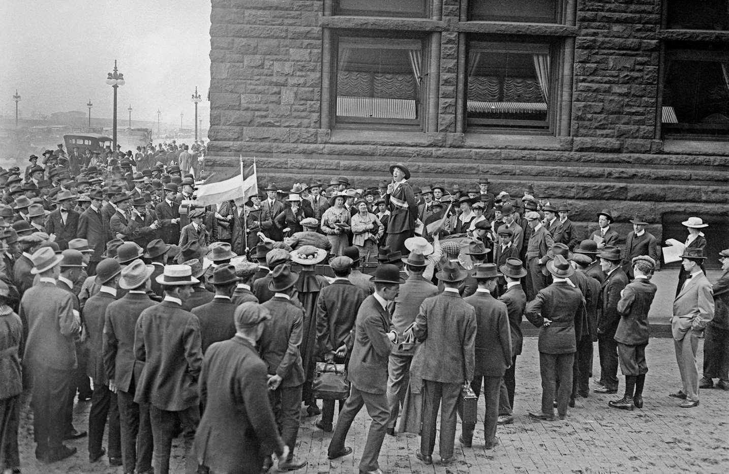Mabel Vernon, a suffragist, speaking to a crowd on the corner of East Van Buren Street and South Michigan Avenue in the Loop community area of Chicago, Illinois, 1916