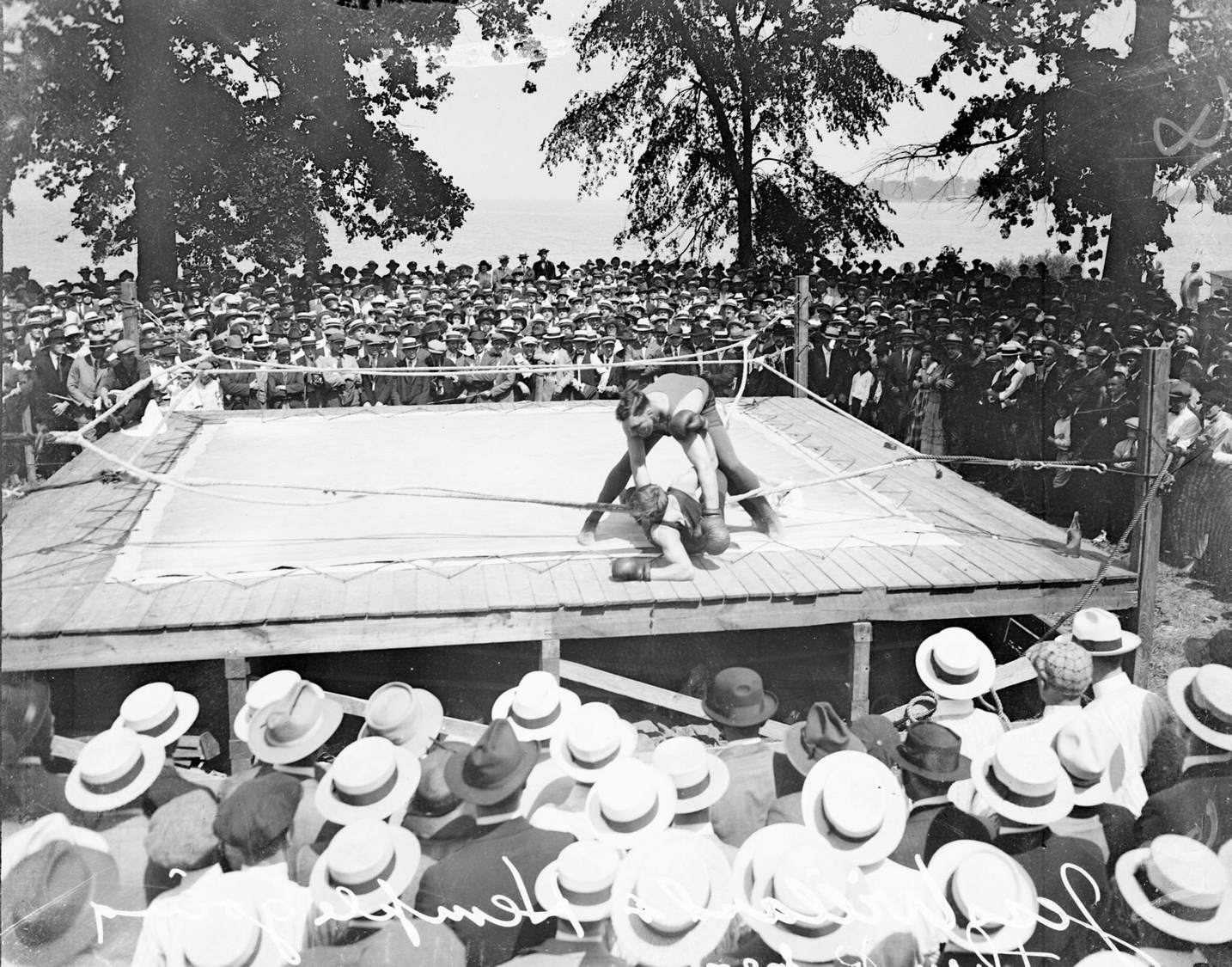 Boxers Jess Willard and Jack Hemple sparring in a ring located near Lake Michigan in Chicago, Illinois, 1916.