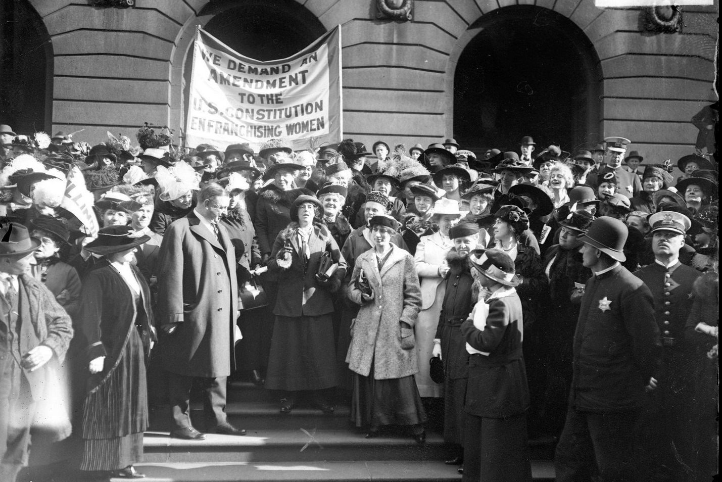 Sara Bard Field, a poet and suffragist, standing in the midst of suffragists in front of the Art Institute of Chicago, located at 111 South Michigan Avenue in the Loop community area, Chicago, Illinois, December 30, 1915.