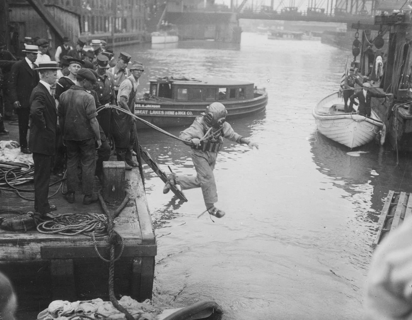 Diver with diving bell leaping into water outside Eastland crash site, Chicago, Illinois, July 24, 1915