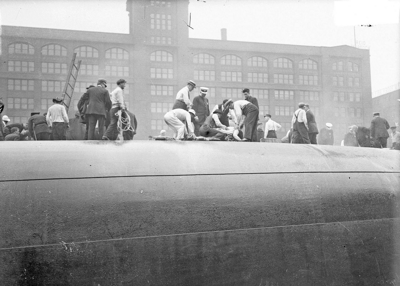 Rescuers and survivors atop the hull of the overturned Eastland steamer in the Chicago River, Chicago, Illinois, circa July 24, 1915.