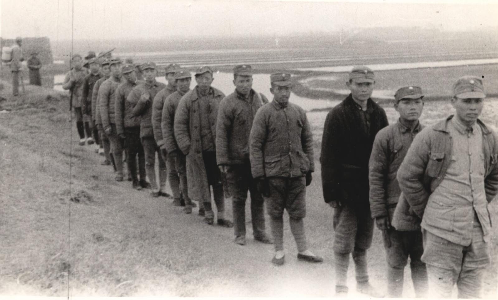 A column of Chinese puppet soldiers who fought for the Japanese. Captured by the New Fourth Army Storm Guerrilla Detachment in battle. These men were either conscripted or captured and put in the Japanese puppet forces.1937-1940